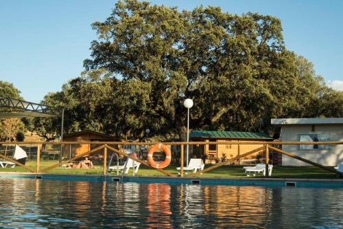 a house with a dock next to a body of water at Complejo The Dreams in Cazalegas