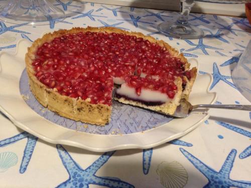 a raspberry pie on a plate on a table at La Casa del Limoneto in Favignana
