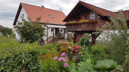 a garden with flowers in front of a house at Haus Willi - kleine & schnuckelige Ferienwohnung in Ortenberg mit WLAN Balkon Parkplatz - neu & sauber & gemütlich in Ortenberg