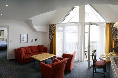 a living room with a couch and a table at Landhaus Mühlenberg in Willingen