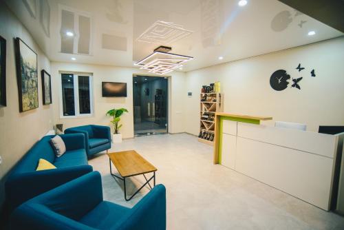 a waiting room with blue chairs and a table at Hotel Sani Kutaisi in Kutaisi