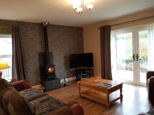 a living room with a couch and a wood stove at Atlantic View Apartments in Limavady