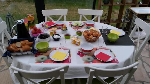a white table with food on top of it at Aux doux Becots - Bed & Breakfast in Hardelot-Plage