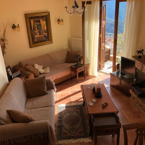 a living room with a couch and a table at Arahova Cozy Apartment in Arachova