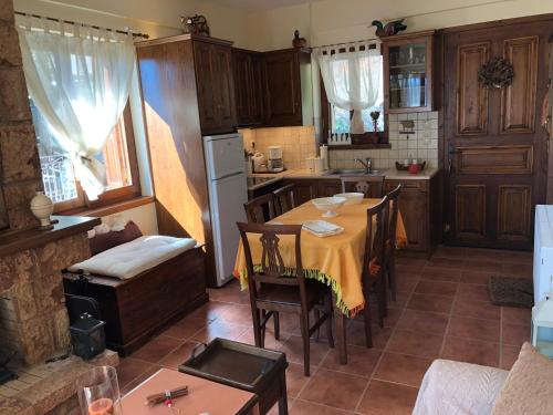 a kitchen with a table and chairs in a kitchen at Arahova Cozy Apartment in Arachova