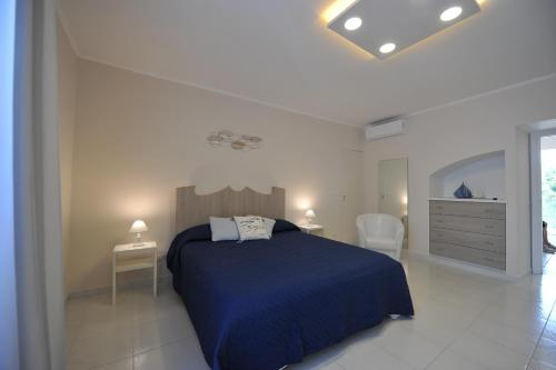 a bedroom with a bed and two tables and a dresser at Casa Irene in Piano di Sorrento