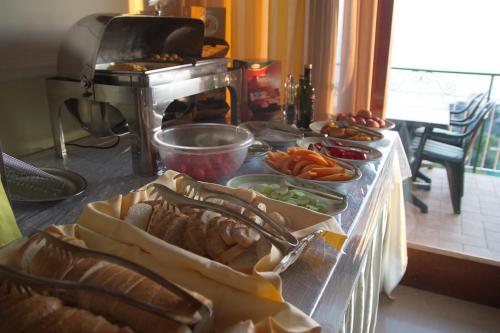 a table with a bunch of food on a counter at Hotel Il Nido Sorrento in Sorrento