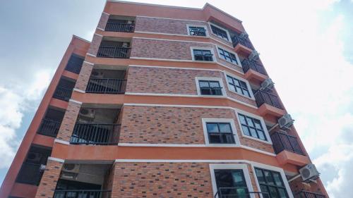 a tall brick building with windows on it at The Old Inn in Udon Thani