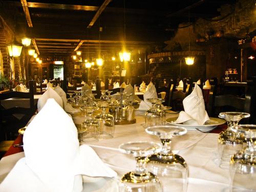 a table with glasses and napkins on it at Hotel Restaurant Bujtina e Gjelit in Tirana