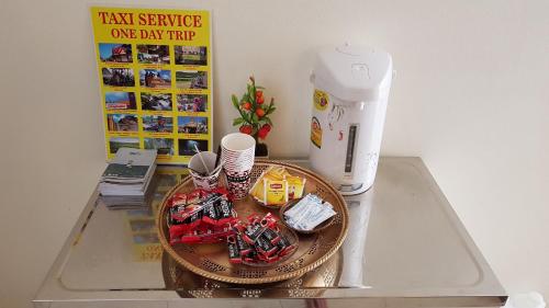 a table with a mixer and a plate with toys on it at Baan Taweesuk Guest House in Hua Hin