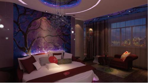 a bedroom with a bed and a tree painting on the wall at Thank Inn Chain Hotel Shandong Qingdao Development Zone Lingzhushan in Qianwan