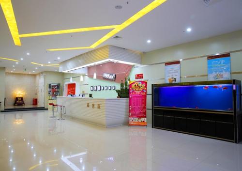 a store with a large tv in the middle of a room at Thank Inn Chain Hotel Hebei Handan Guantao Zhuxian Road in Nanxinzhuang