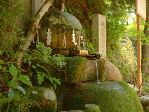 a water fountain in the middle of a garden at Ryotei Yamanoi in Matsue