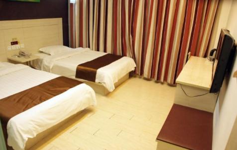 a hotel room with two beds and a television at Thank Inn Chain Shandong Zaozhuang Taierzhuang Gucheng Development Area Rapid Bus Station in Zaozhuang