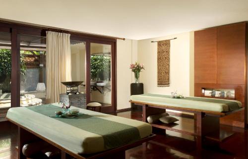 a living room with two beds and a table at Novotel Bali Nusa Dua in Nusa Dua