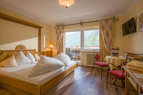 a hotel room with a bed and a window at Das Rotspitz Adults - only in Maurach