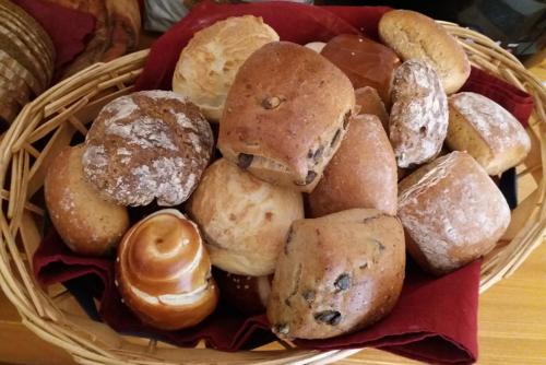 a basket of different types of donuts and pastries at B&B - Apartments Sunnwies in Marlengo