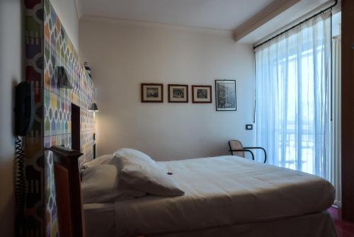 a bedroom with a bed and a large window at La Moresca in Ravello
