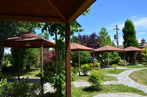 a group of umbrellas in a garden at Agriturismo Cascina Maiocca in Mediglia