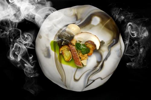 a smoke image of a object with food in it at En Marge in Aureville
