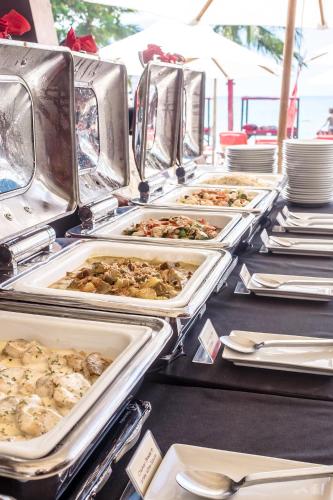 a buffet with many trays of food on a table at Beach Republic Koh Samui in Lamai