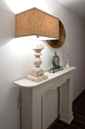 a table with a lamp on top of it at Anita Home in Gyenesdiás