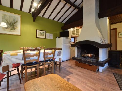 a living room with a table and a fireplace at detached chalet in lovely hiking region in Bellevaux