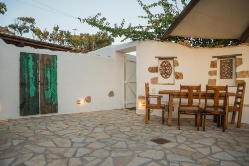 a dining room with a table and chairs at Anemos Houses in Skala