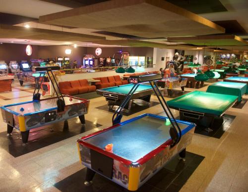 a room full of ping pong tables in a bar at Rodos Palace Hotel in Ixia