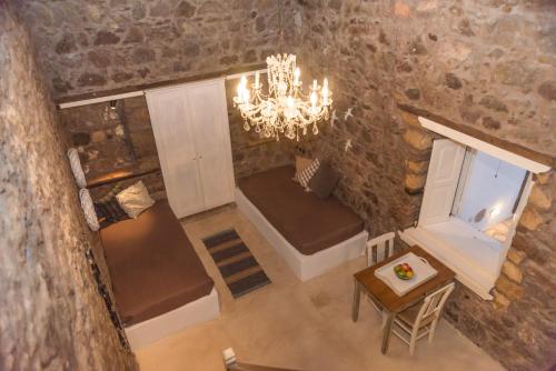 an overhead view of a living room with a chandelier at Anemos Houses in Skala