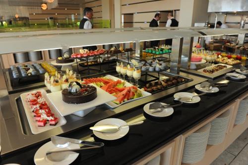 a buffet line with many different types of food at Rodos Palace Hotel in Ixia