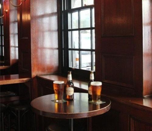 two bottles of beer and two glasses on a table at Grand Hotel Sydney in Sydney