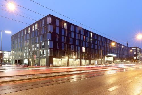 a building on the side of a street at night at Eurostars Grand Central in Munich