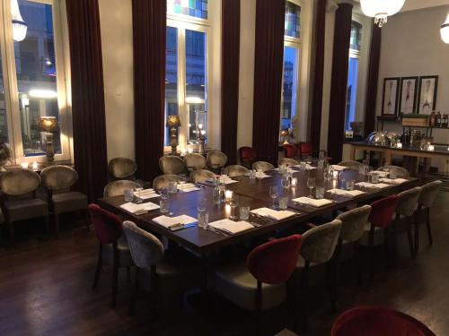 a long table in a room with chairs at Villa Rubenshof in Helmond