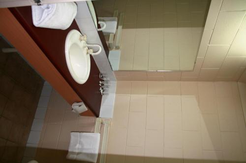 a bathroom with a toilet and a sink at Luma Luma Holiday Apartments in Darwin