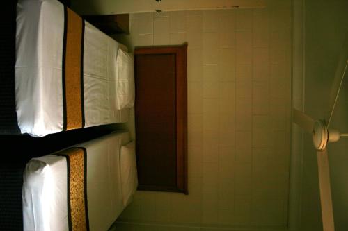 a group of white towels on a shelf in a bathroom at Luma Luma Holiday Apartments in Darwin