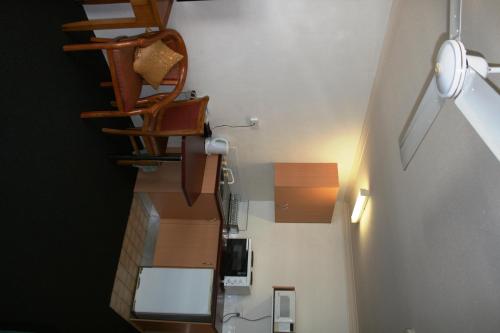 a staircase in a room with wooden furniture at Luma Luma Holiday Apartments in Darwin