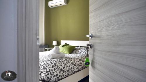 a bedroom with a bed with green walls at Nonna Francesca in Patti