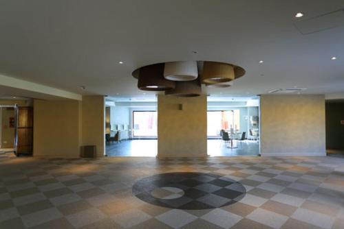 a large room with a checkered floor in a building at Turin Airport Hotel & Residence in San Francesco al Campo