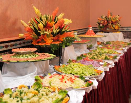 a buffet line with many plates of food at Diwane Hotel & Spa Marrakech in Marrakech