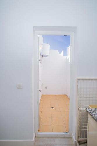 a kitchen with a door leading into a room at Flower Beach Suite 6 in Playa Honda