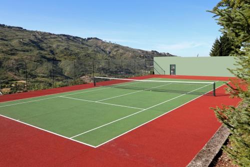 a tennis court with two tennis nets on it at Quinta da Timpeira in Lamego