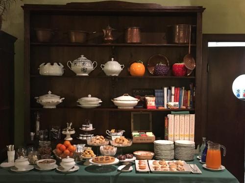a table topped with dishes and tea pots and bowls at Agriturismo Cascina Maiocca in Mediglia