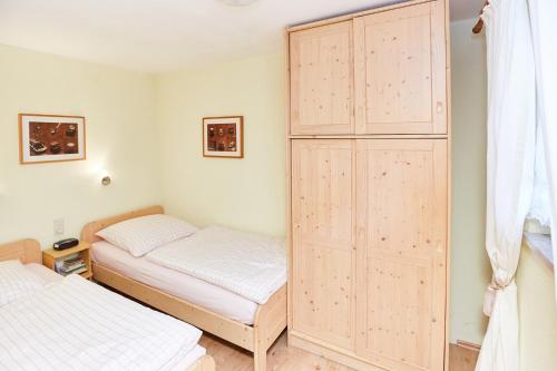 a bedroom with two beds and a large closet at Haus Deidl in Bad Hindelang