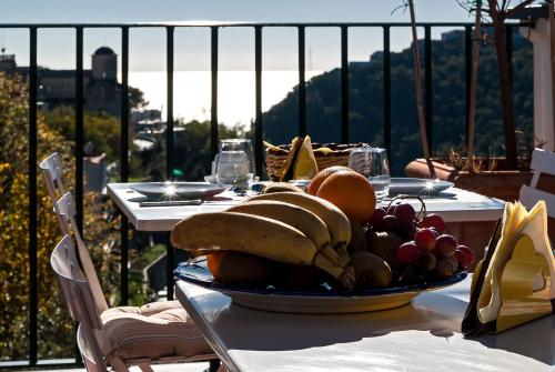 a plate of fruit on a table on a balcony at La Moresca in Ravello
