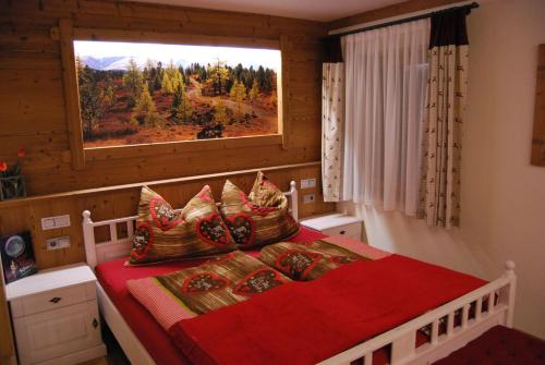 a bedroom with a bed with a large window at Landresidenz s'Daham in Heiligenblut