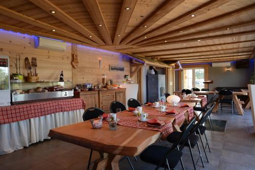 a restaurant with wooden ceilings and wooden tables and chairs at Les Coteaux du Vinave in Herve