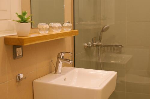 a bathroom with a sink and a shower at Casa Mia Apartments in Agios Nikolaos