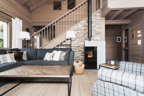 a living room with a couch and a fireplace at Chalet Kristall in Rosswald