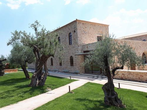 two olive trees in front of a building at Mystras Grand Palace Resort & Spa in Mystras